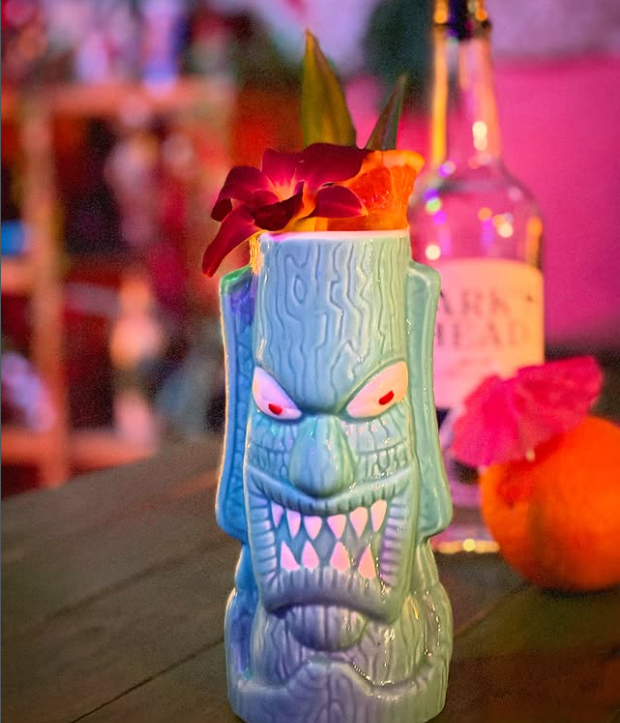 The Boca Loca served in a glowing blue tiki mug with orchids